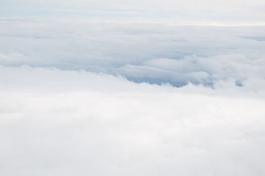 Aerial view above fluffy white cloudscape