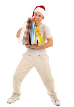 Young Santa with heavy purchases in paper bags on white background