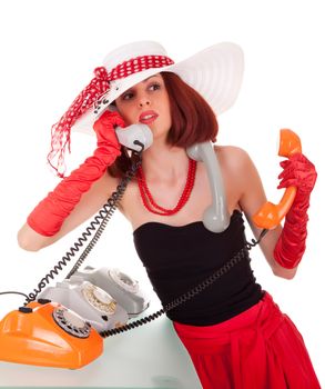 Confused fashion girl in retro style with three vintage phones on white background