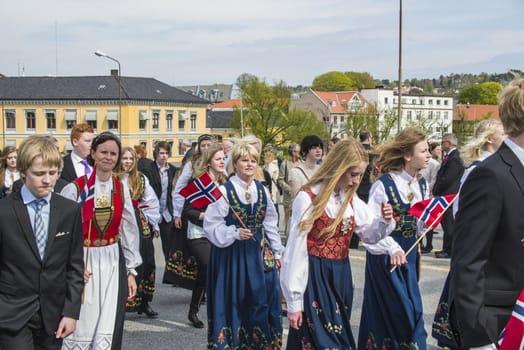 Norwegian Constitution Day is the National Day of Norway and is an official national holiday observed on May 17 each year. This day is also often called the Children's Day. The picture is shot in the center of Halden City.