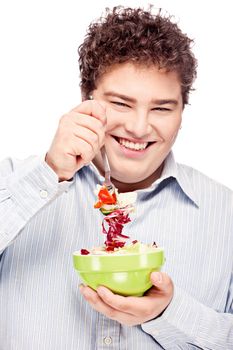 Happy young chubby man with fresh salad in dish, isolate on white