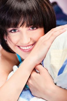 Cute smiling girl on pillow