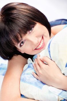 Cute smiling short hair girl on pillow