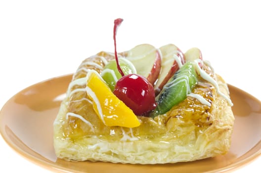 Apple Danish Topped With Glazed Fresh Fruit on brown dish