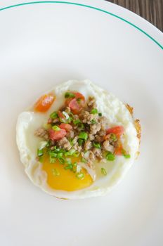 top view fried egg with minced pork and vegetable on white dish