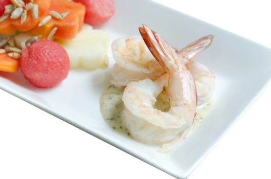close up  boiled shrimp , cream sauce and mixed fruits on dish over white background