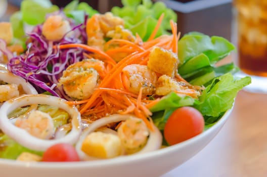 close up shrimp and vegetable salad with  sauce in white bowl , (selective focus)