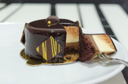 close up Coffee mousse cake with  dark chocolate , sweet dessert with fork 