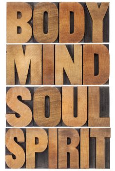 body, mind, soul and spirit typography - a collage of isolated words in vintage wood letterpress type scaled to a rectangle