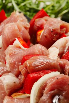 Shashlik - Oriental food. The pieces of raw meat on the skewers. Closeup. Limited depth of field.