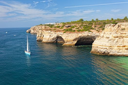 sailing yacht near Praia de Benagil, Algarva, the Atlantic coast of Portugal