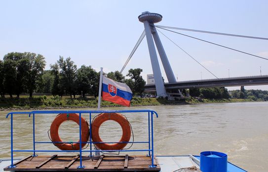 Nov� Most Bridge, view from a boat of  the famous "Ufo" tower, Bratislava. Slovakia (Flag in the foreground)