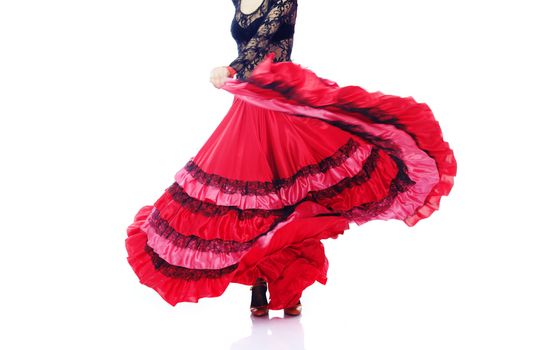 Woman dancing flamenco in Spanish costume on a white background