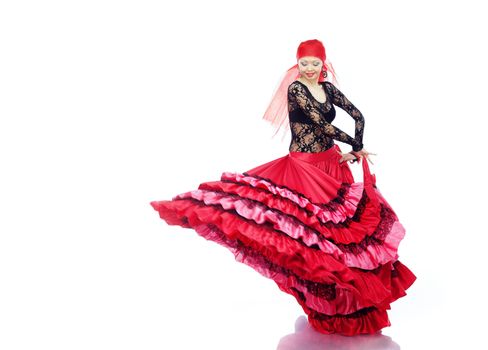 Smiling lady dancing Flamenco in traditional costume