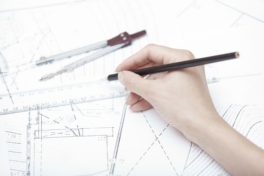 Hands of engineer working on a construction plan