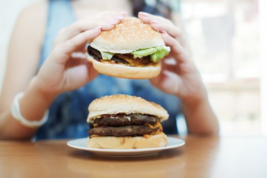 Woman eating hamburgers