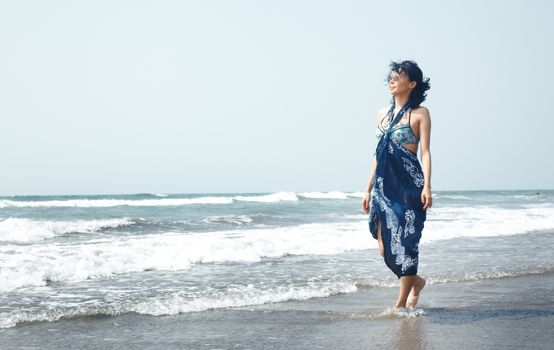 Woman walking at the sea in vacation