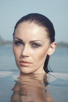 Elegant lady at summer beach. Vertical photo