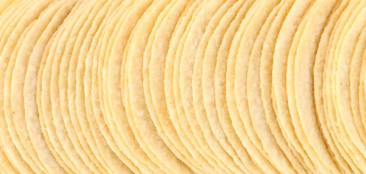 Background of potato chips in row. Whole background.