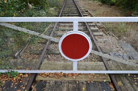 Railway stop barrier in its closed postion.Shot taken in Southern England on a rural line.