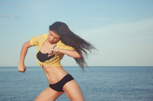 Woman dancing at the sea