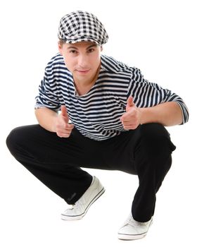 Thumbs up! by look naughty handsome young man in stylish striped dress and cap with suitcase