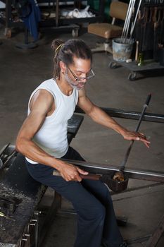 Handsome Black man working on fine art glass jar