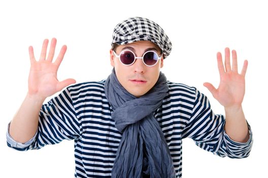 Yielding naughty handsome young man in stylish striped dress, glasses and cap with suitcase