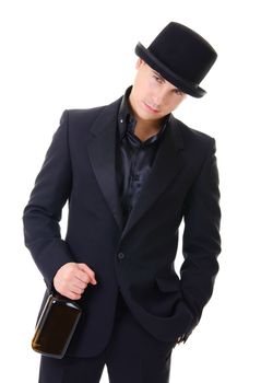 Serious man with whisky bottle in black suit and hat in austere style isolated on white background