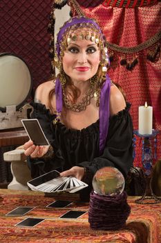 Charming sexy European tarot card reader in headscarf