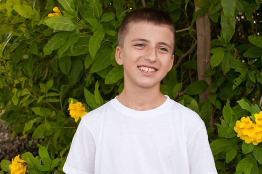 Portrait of a cute young boy outside .