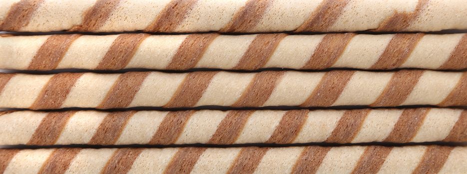 Background of waffle rolls with chocolate cream