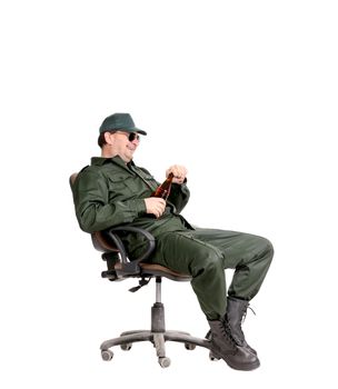 Man in workwear sitting with beer. Isolated on a white background.