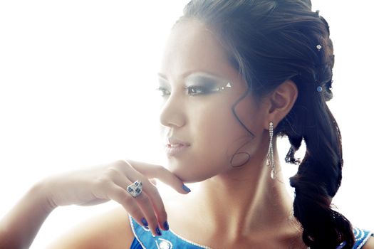 Beautiful Asian lady with luxurious accessories. Backlight added