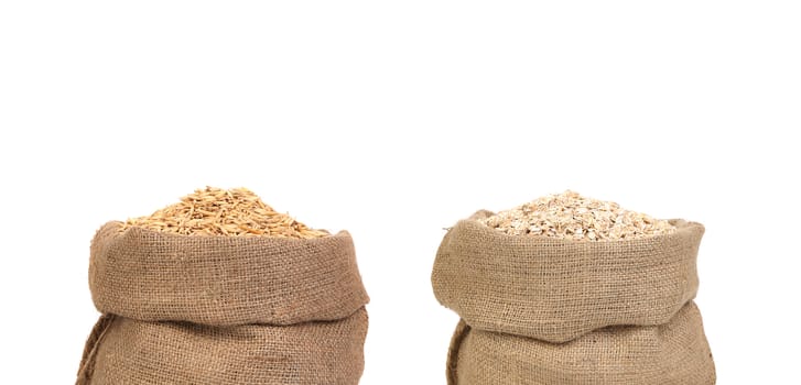 Bags with barley and rolled oat. Isolated on a white background