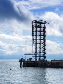 At the edge of the lake Bodensee with view to a belvedere in the town Friedrichshafen, Germany