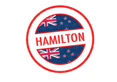 Passport-style HAMILTON rubber stamp over a white background.