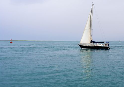 Recreation boat at sunset, in Ria Formosa, natural conservation region in Algarve, Portugal. 