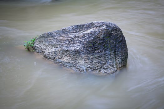Stone in flowing water