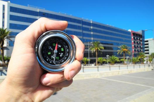 Orientation Concept a Male Hand Holding a Metal Compass in a City