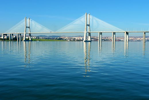 View from river Tagus of Lisbon's Nations park and "Vasco da Gama" Bridge, Portugal                           