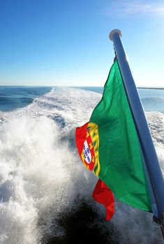 View of Lisbon's river Tagus and Portuguese flag, Portugal                           