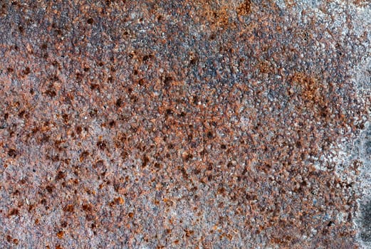 Old rusty metal plate heavily aged and corroded