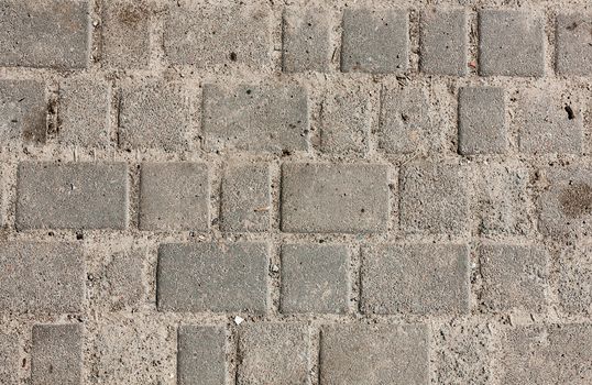 Seamless tileable texture of paving slabs the sand