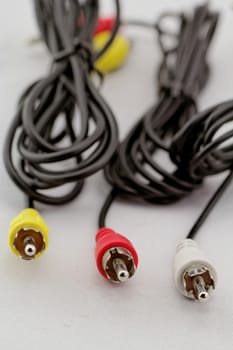 three audio (left - right) - video RCA cable and plug (red, white, yellow) on white background