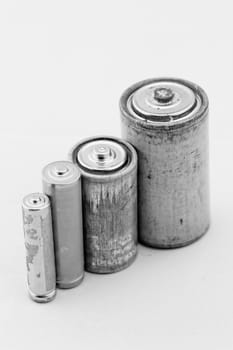 Old grey batteries on white background (aa, aaa, b, c)