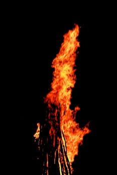 red flames of huge bonfire or campfire as black backgorund