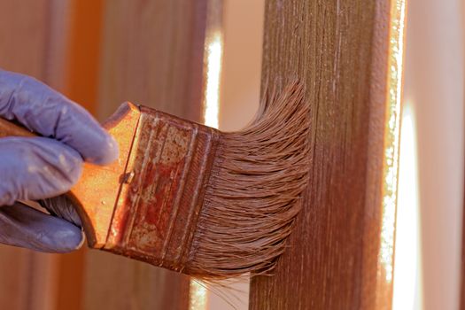 planks fence dyeing with brown paint and brush