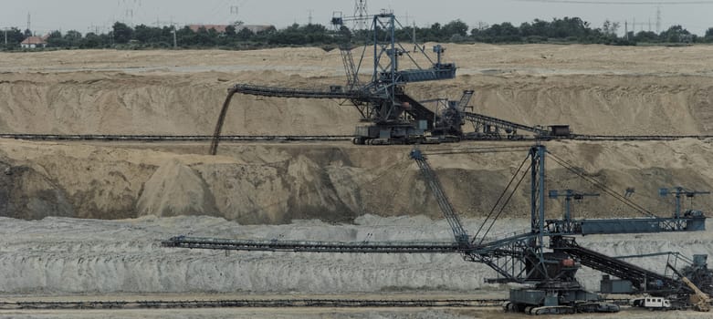 Coal mining in an open pit with huge industrial machine