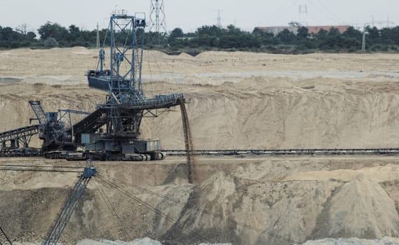 Coal mining in an open pit with huge industrial machine